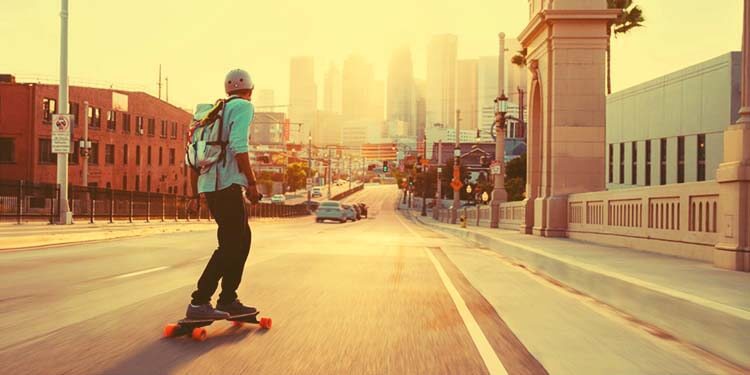 teen commuting on electric skateboard
