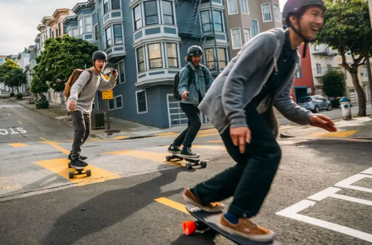 group of teens riding electric skateboards