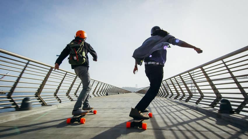 two man riding on electric skateboards