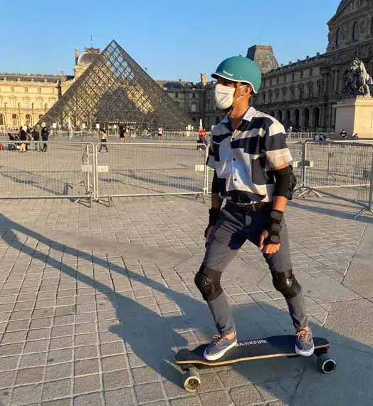 man riding electric skateboard backfire g2 black 2020 in paris