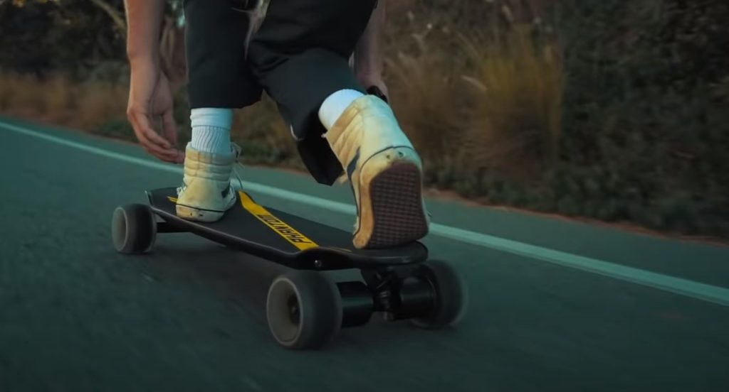 man riding on miles phantom electric skateboard
